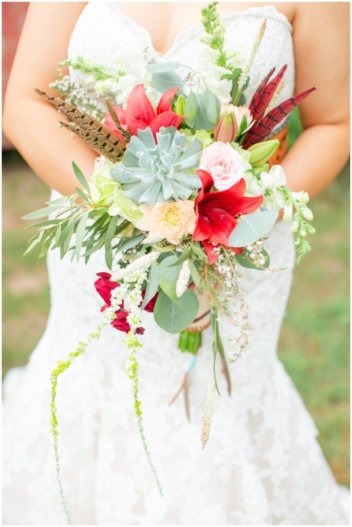 A unique bridal bouquet replete with succulents, feathers, and bright spring florals.