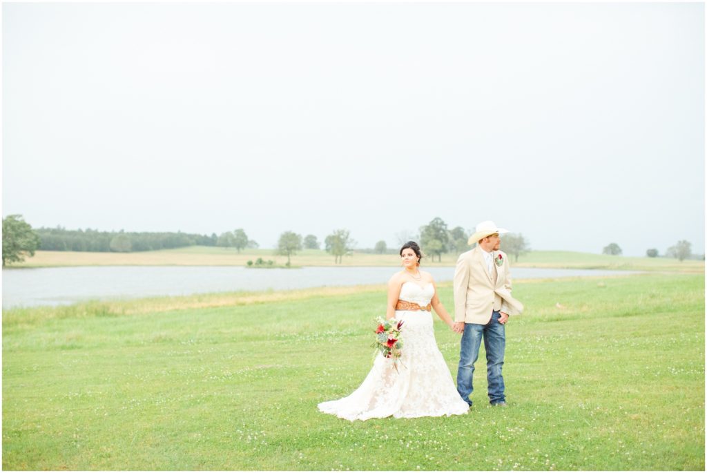 A bride and groom stand alone in an open field in Spring in the Texas hillcountry.