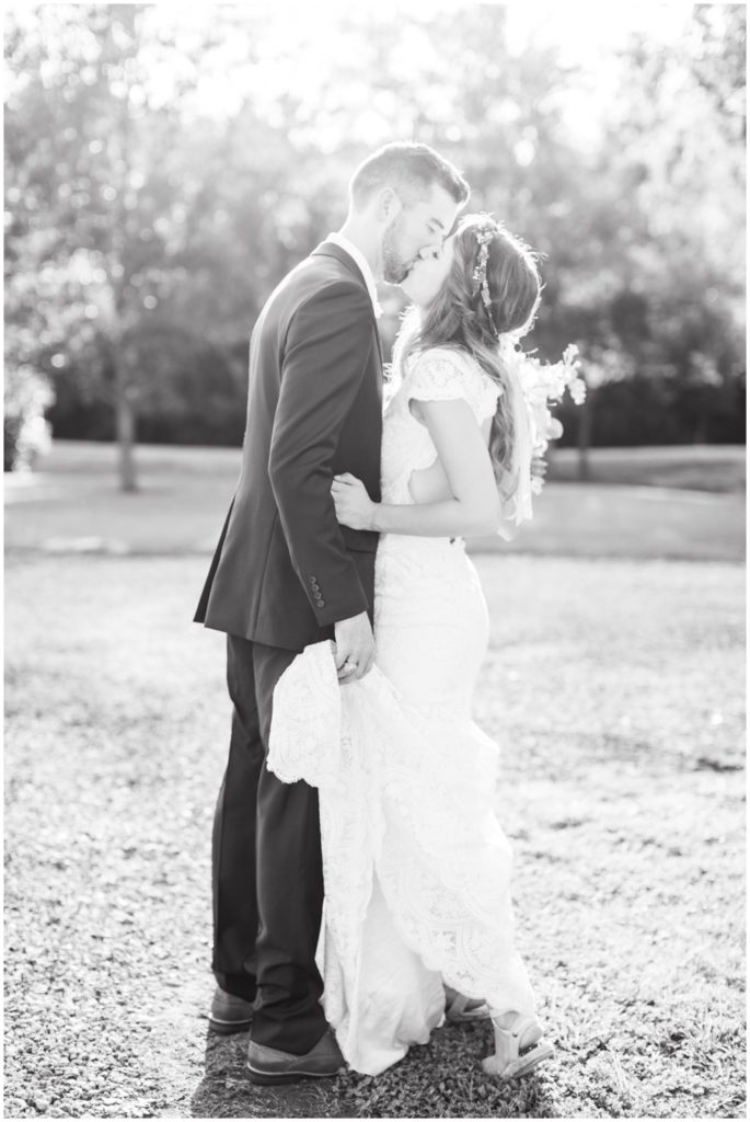 A bride and groom share a magical kiss under a warm sunset.