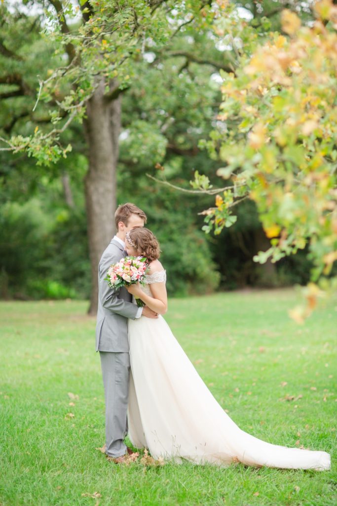 A bride and groom share an emotional first look under big Texas oak trees in the hill country.