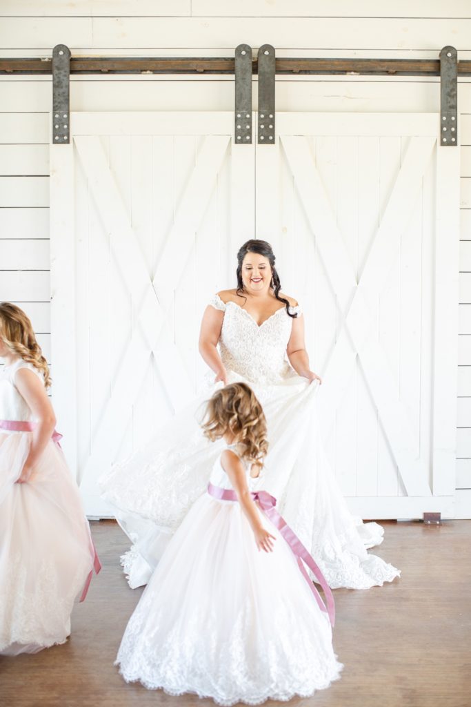 A bride dances with her flower girls.