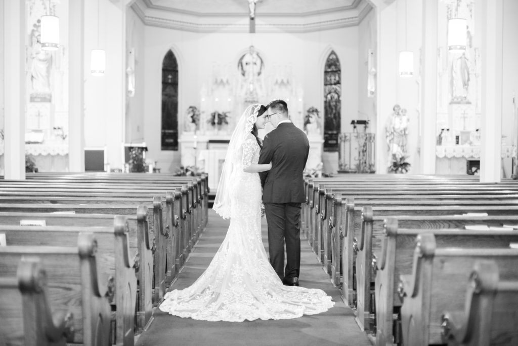 A bride and groom share a moment in their wedding chapel alone after the ceremony.