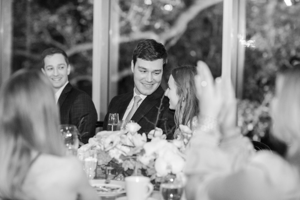 groom smiles at bride during their rehearsal dinner